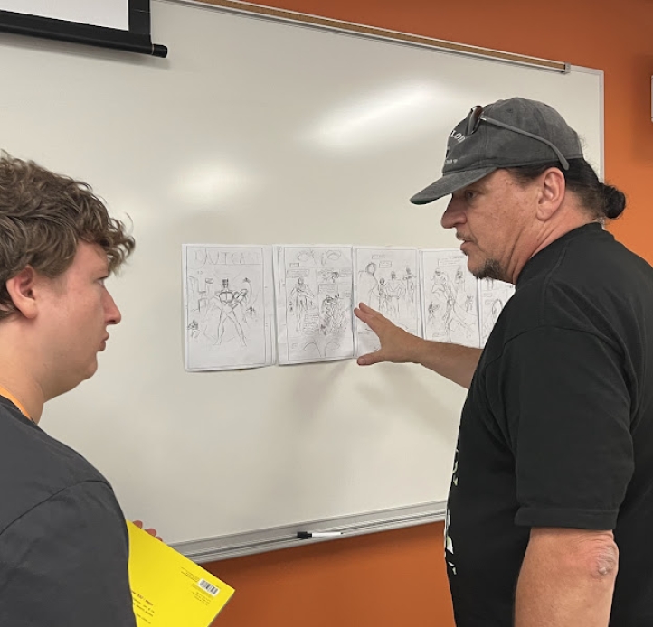 Comic Book Camp instrutor teaching a young man
