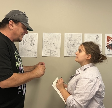 Comic Book Camp instrutor teaching a student