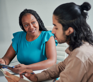 woman coaching a man in an office