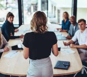woman standing in front of a conference table