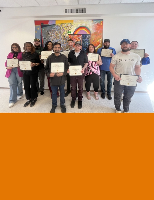 Workshop particpants displaying their certificates of completion