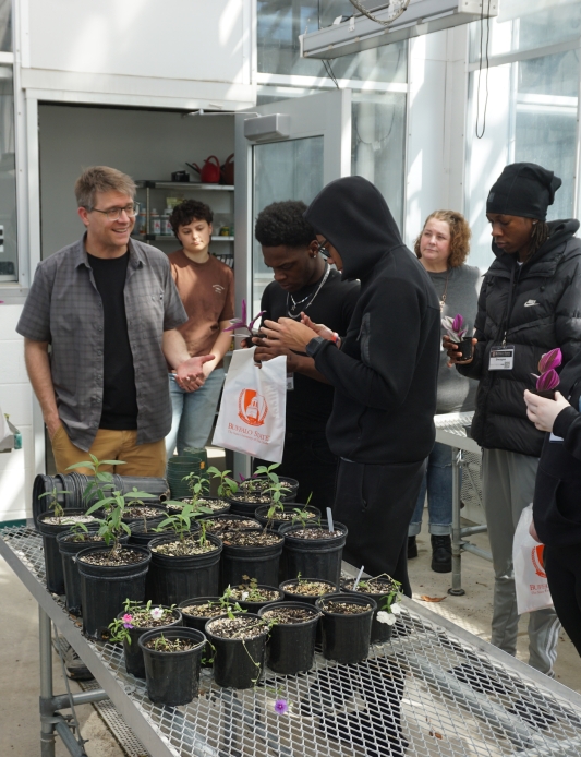 High school students in Buffalo State's greenhouse receiving free plants